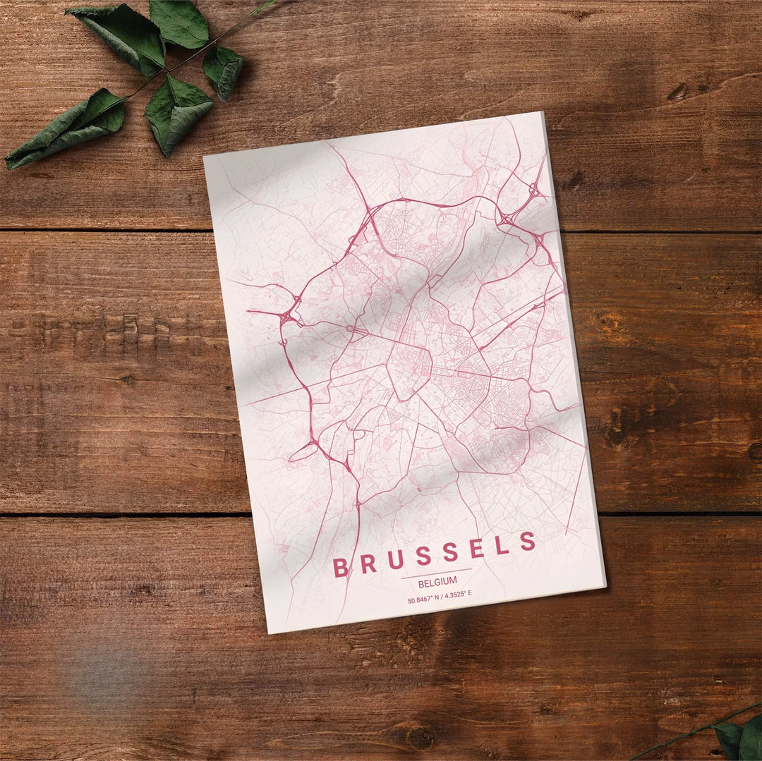 Fine art cartography print depicting the full city grid and coordinates of Brussels, Belgium, in a sleek modern pastel pink style. Offered by MapYourDreams, this artwork is available in flexible options including unframed paper, custom wooden frames, and gallery canvas wraps.