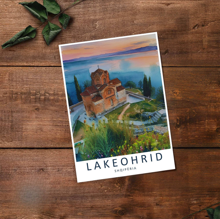 Fine art travel poster showing Lake Ohrid with sunset skies, Byzantine architecture, and relaxed natural scenery across an inviting view. Choose from flexible display setups including unframed archival paper, wooden frames, or wrapped canvas formats.