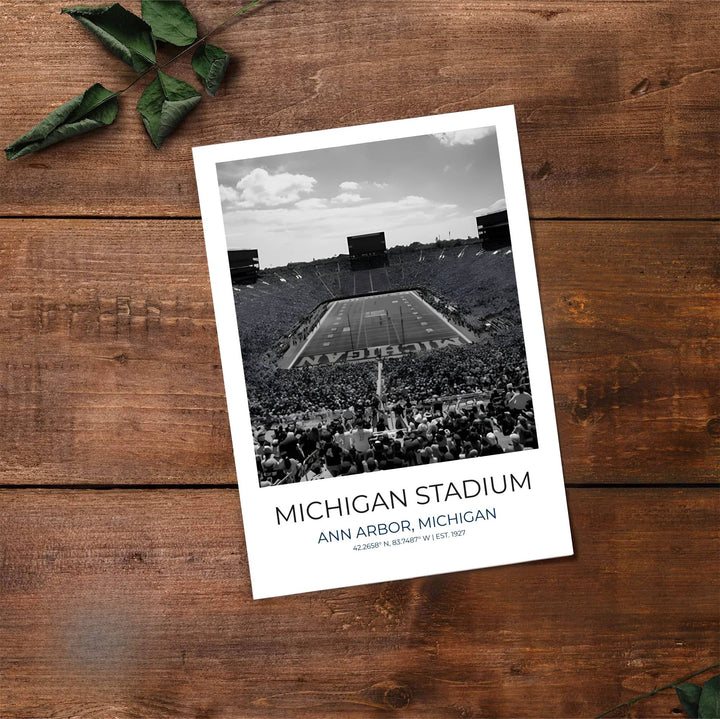 Dramatic black and white photo print of Michigan Wolverines stadium showcasing end zone painted MICHIGAN lettering. Made by MapYourDreams, this artwork is available in flexible options including unframed paper, custom wooden frames, and gallery canvas wraps for living space wall art.