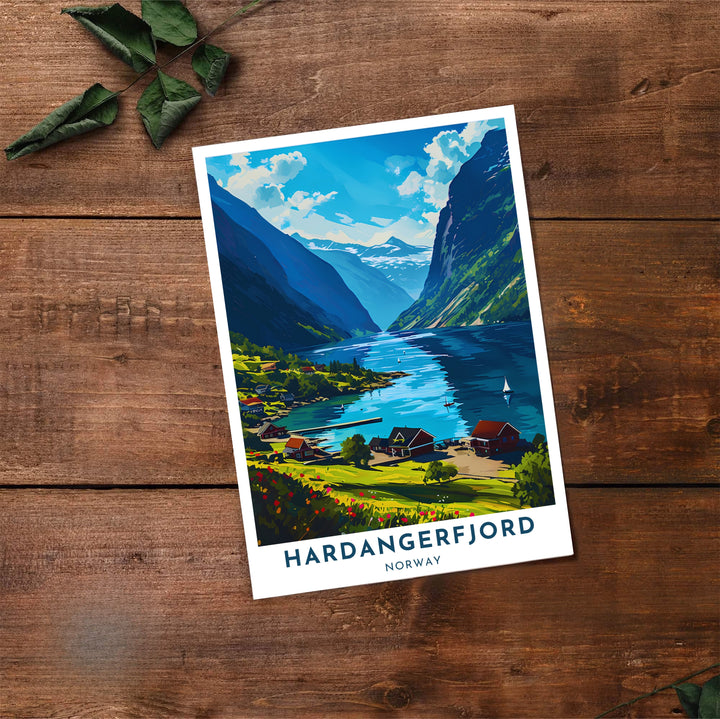 Coastal landscape poster depicting Hardangerfjord in Norway with wooden docks, red cottages, and sailboats on sparkling blue waters. Bring Scandinavian warmth into your home with this print available in classic unframed paper, gallery wrapped canvas panels, or fully assembled framed displays.