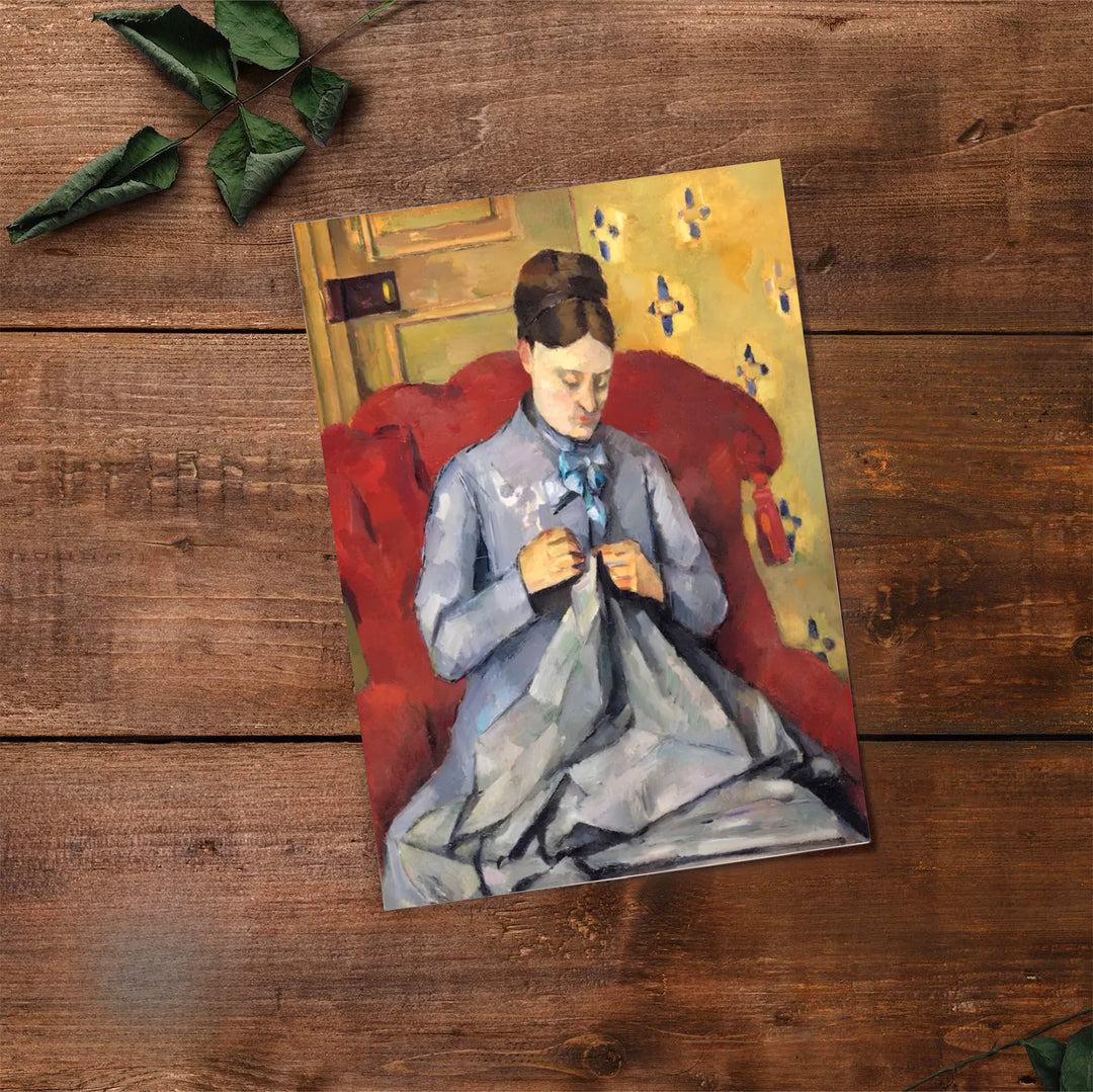Classical art print of Paul Cezanne Madame Cezanne Sewing 1877 showing a woman seated in a red chair in Paris France. Select premium framed wall art, unframed paper prints, and stretched canvas decor options at MapYourDreams for an eye-catching focal point in your hall.