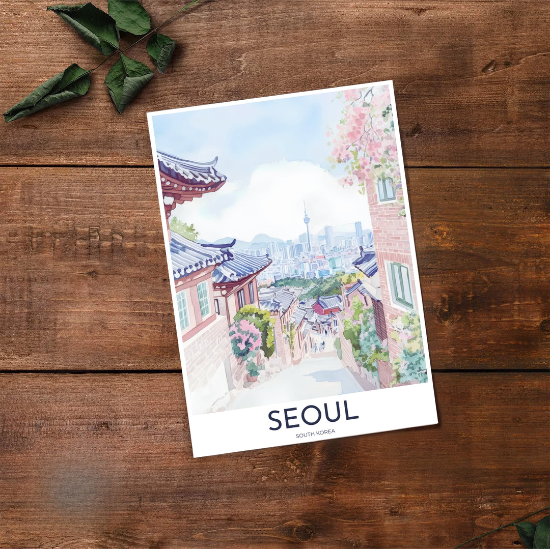 Delicate watercolor travel print of Seoul, South Korea, featuring slate blue tiled roofs, blush pink cherry blossom petals, warm brick walls, and a soft periwinkle mountain horizon. Offered by MapYourDreams, this artwork is available in flexible options including unframed paper, custom wooden frames, and gallery canvas wraps.