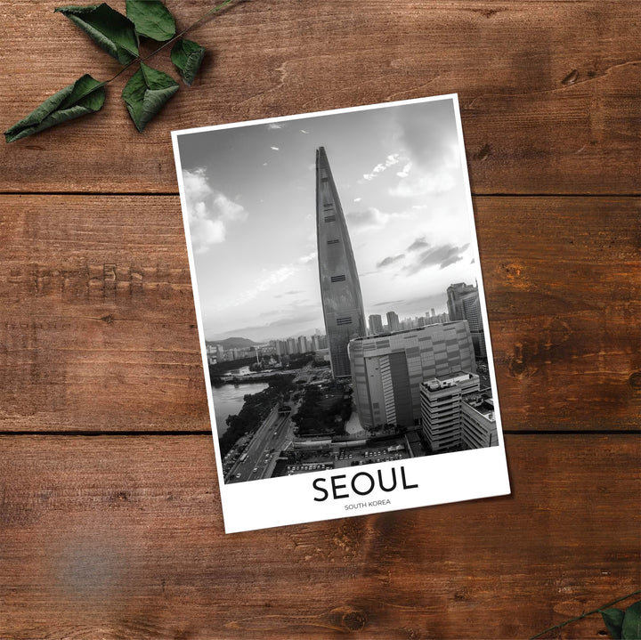 Grayscale urban landscape poster showing Lotte World Tower rising above Seoul city buildings and waterways, created by MapYourDreams in flexible formats including unframed prints, retro black frames, and stretched canvas that transform empty walls into captivating conversation starters.