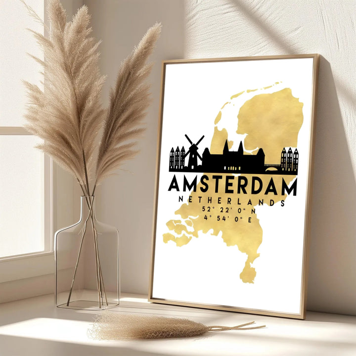 Elegant metallic map print featuring a gold silhouette of the Netherlands and black Amsterdam architectural highlights, provided by MapYourDreams as an unframed paper print, a gallery wrapped canvas, or a custom framed presentation style for lovers of high-contrast modern art.