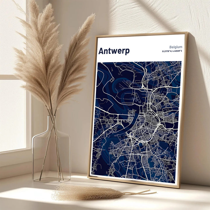 A refined city map print showcasing the street grid and geographical outline of Antwerp, Belgium, in rich navy blue and crisp white. Offered in flexible choices such as unframed archival poster paper, custom wood framing, and gallery canvas wraps.