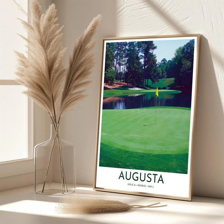Modern photographic golf print featuring text reading AUGUSTA HOLE 16 REDBUD PAR 3 below a stunning view of the 16th green and pond. Offered by MapYourDreams, this artwork is available in flexible options including unframed paper, custom wooden frames, and gallery canvas wraps for tailored home wall decor setups.