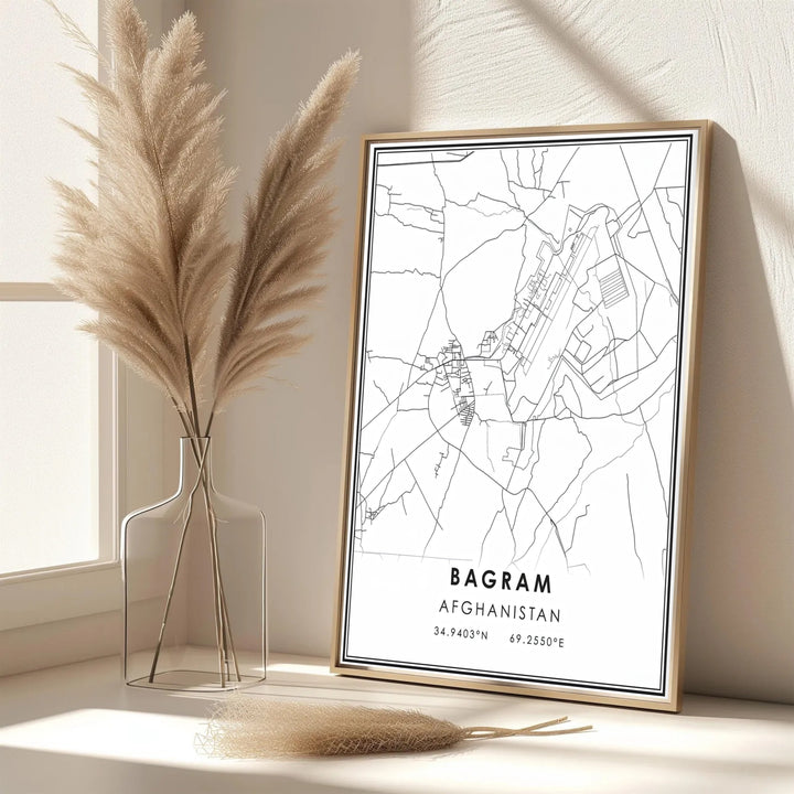 Minimalist black and white poster of Bagram Afghanistan showcasing geographic road networks and coordinate details, created by MapYourDreams with options for unframed art prints, stretched canvas wall decor, or custom framed prints in gold and classic black frame finishes.
