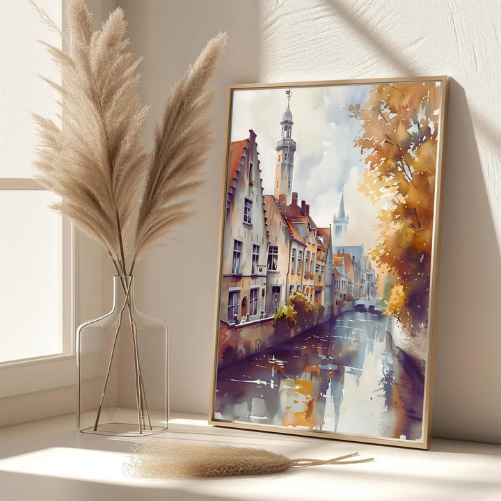 A refined European watercolor print showcasing the fairytale canal scenery of Bruges, Belgium, in amber gold, peach, and muted lavender shadows. Offered in flexible choices such as unframed archival poster paper, custom wood framing, and gallery canvas wraps.