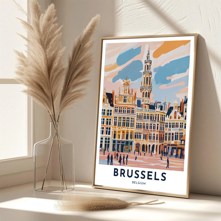 A picturesque Belgian cityscape print featuring the guild house facades and Town Hall of Brussels Grand Place in Belgium under a soft peach sky. Offered in flexible choices such as unframed archival poster paper, custom wood framing, and gallery canvas wraps.