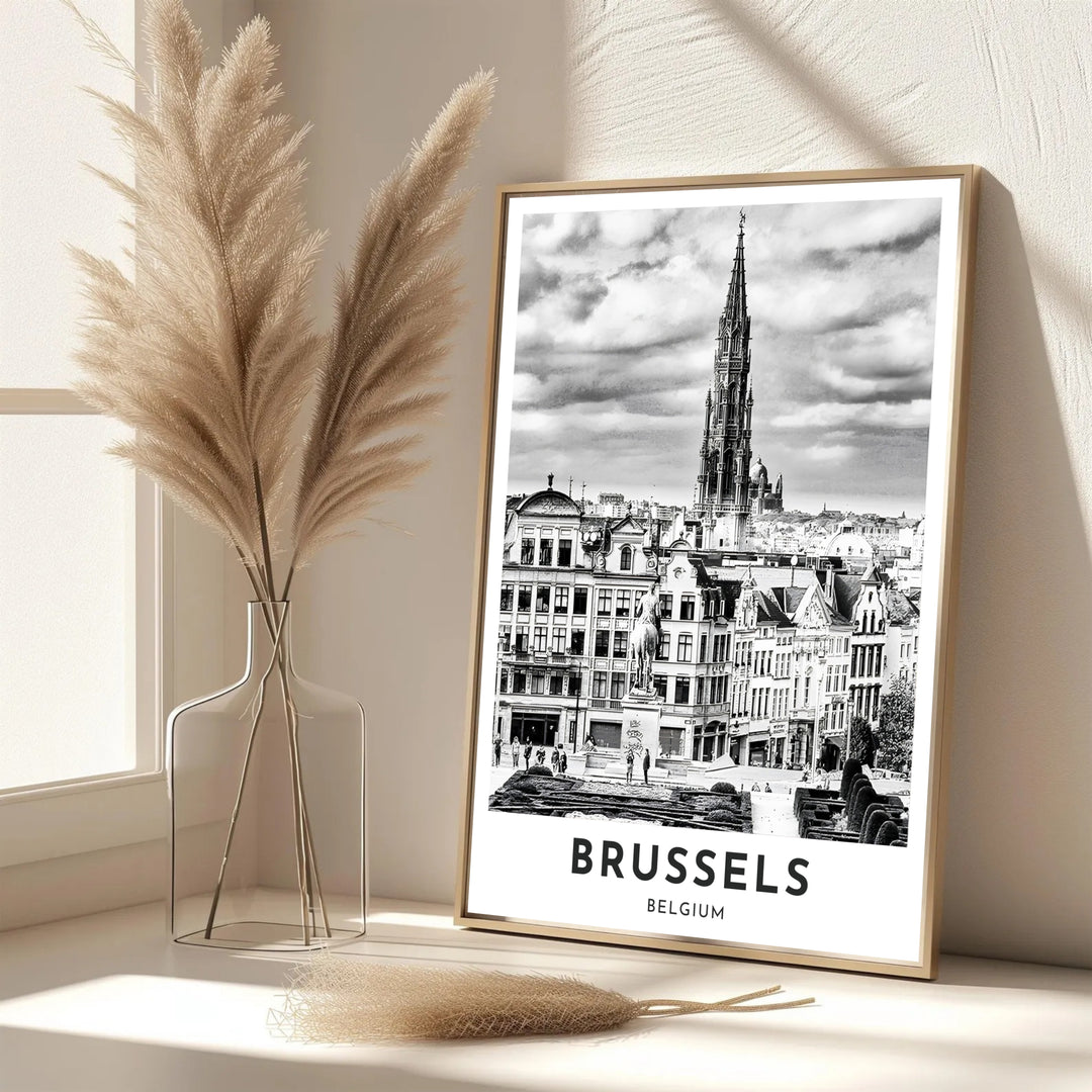 A striking black and white skyline print showcasing the detailed Town Hall spire and dramatic cloudscape of Mont des Arts in Brussels, Belgium. Offered by MapYourDreams, this artwork is available in flexible options including unframed paper, custom wooden frames, and gallery canvas wraps.
