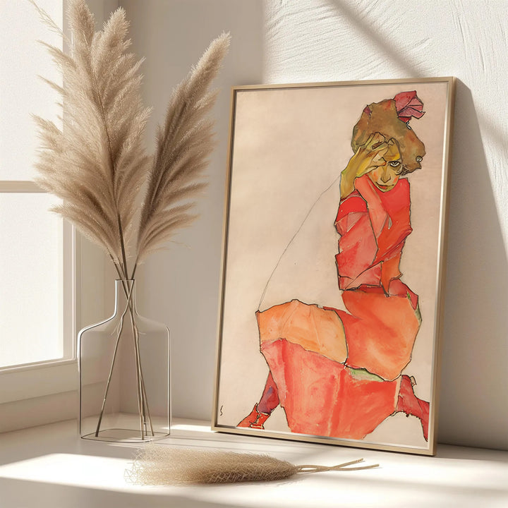 Elegant red dress portrait poster of Egon Schiele Kneeling Female In Orange Red Dress 1910 in Leopold Museum Vienna with authentic vintage paper texture. MapYourDreams features custom framed prints, unframed paper wall poster decor, and gallery canvas options for study rooms, hallways, and living areas.