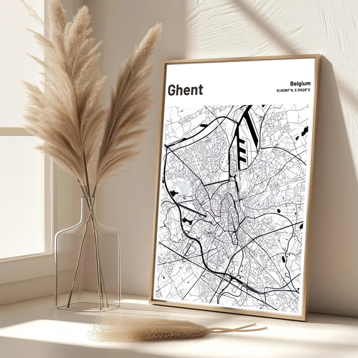 A black and white geographic print showing the road network and waterways of Ghent, Belgium. Offered in flexible choices such as unframed archival poster paper, custom wood framing, and gallery canvas wraps.