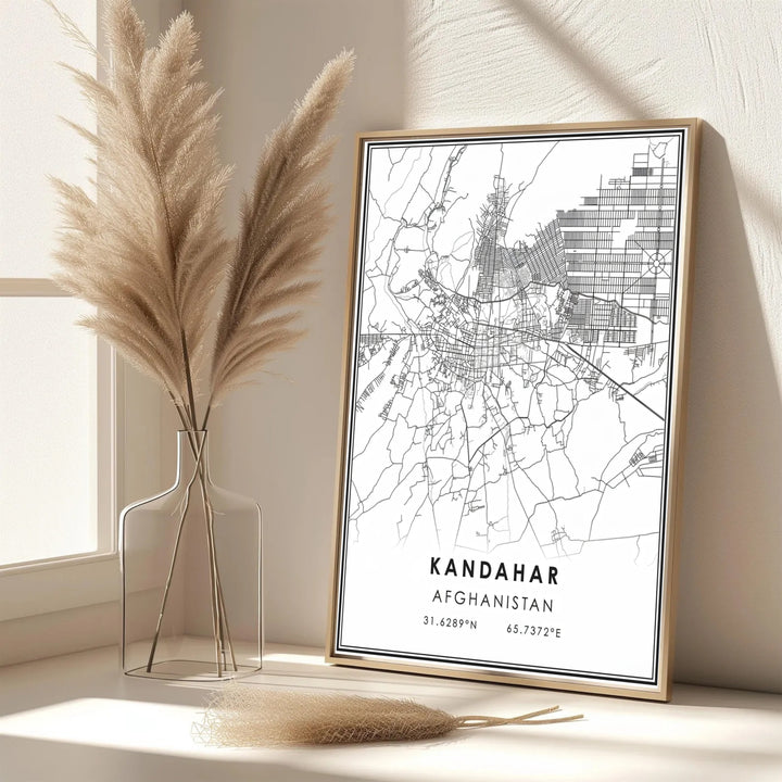 Cartographic wall art poster showcasing street grids, outer road lines, and precise latitude longitude coordinates for Kandahar, Afghanistan. Created by MapYourDreams with options for unframed art prints, stretched canvas wall decor, or custom framed prints in gold and classic black frame finishes.