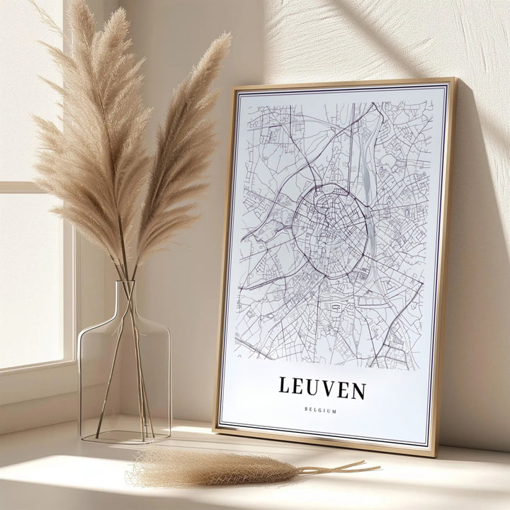 A black and white geographic print showing the road network and inner city core of Leuven, Belgium. Offered in flexible choices such as unframed archival poster paper, custom wood framing, and gallery canvas wraps.