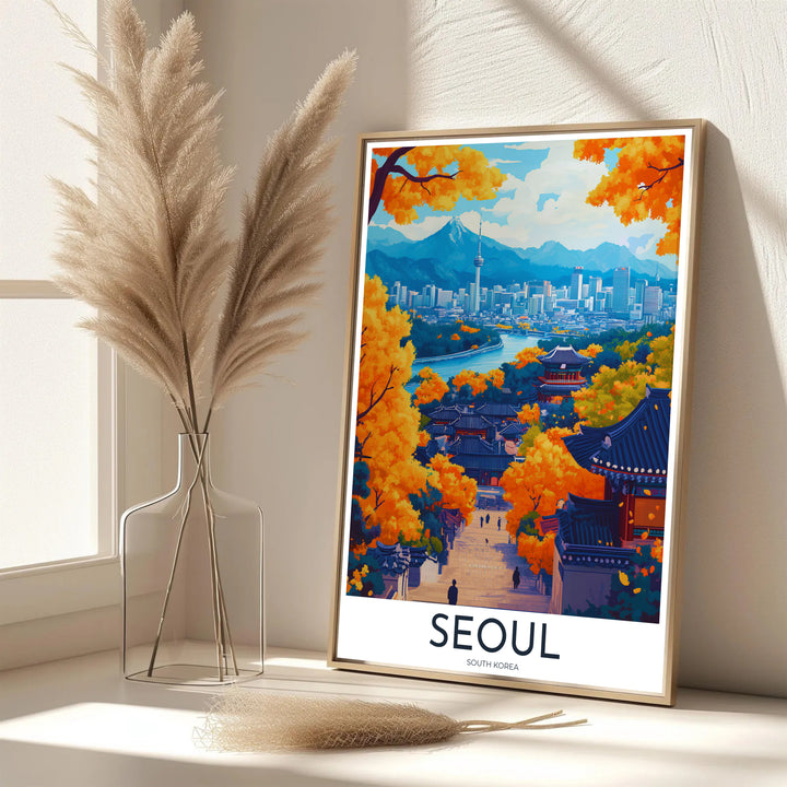 Vibrant South Korean autumn decor print showcasing a picturesque village pathway in Seoul surrounded by golden tree canopies, traditional rooflines, and N Seoul Tower. Offered by MapYourDreams, this artwork is available in flexible options including unframed paper, custom wooden frames, and gallery canvas wraps.
