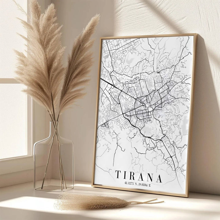 Elegant vertical typography frames this detailed road map of Tirana, offering a clean monochrome aesthetic for home offices and executive spaces. Available from MapYourDreams as an unframed paper poster, custom-framed print, or gallery-wrapped canvas.