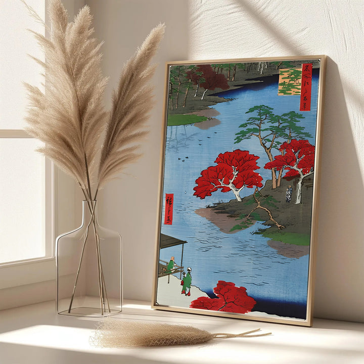 Elegant Japanese autumn poster Akiba Shrine Ukeji by artist Utagawa Hiroshige featuring bright red maple leaves and river water in Akiba Shrine Ukeji. MapYourDreams features framed, unframed, and canvas print options for office wall art decor.