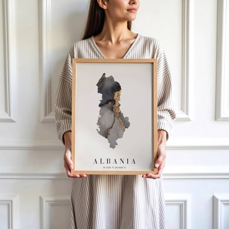 Crisp cartographic artwork showing the country map of Albania in charcoal and metallic gold with modern serif country lettering and coordinates. Offered by MapYourDreams, this artwork is available in flexible options including unframed paper, custom wooden frames, and gallery canvas wraps.