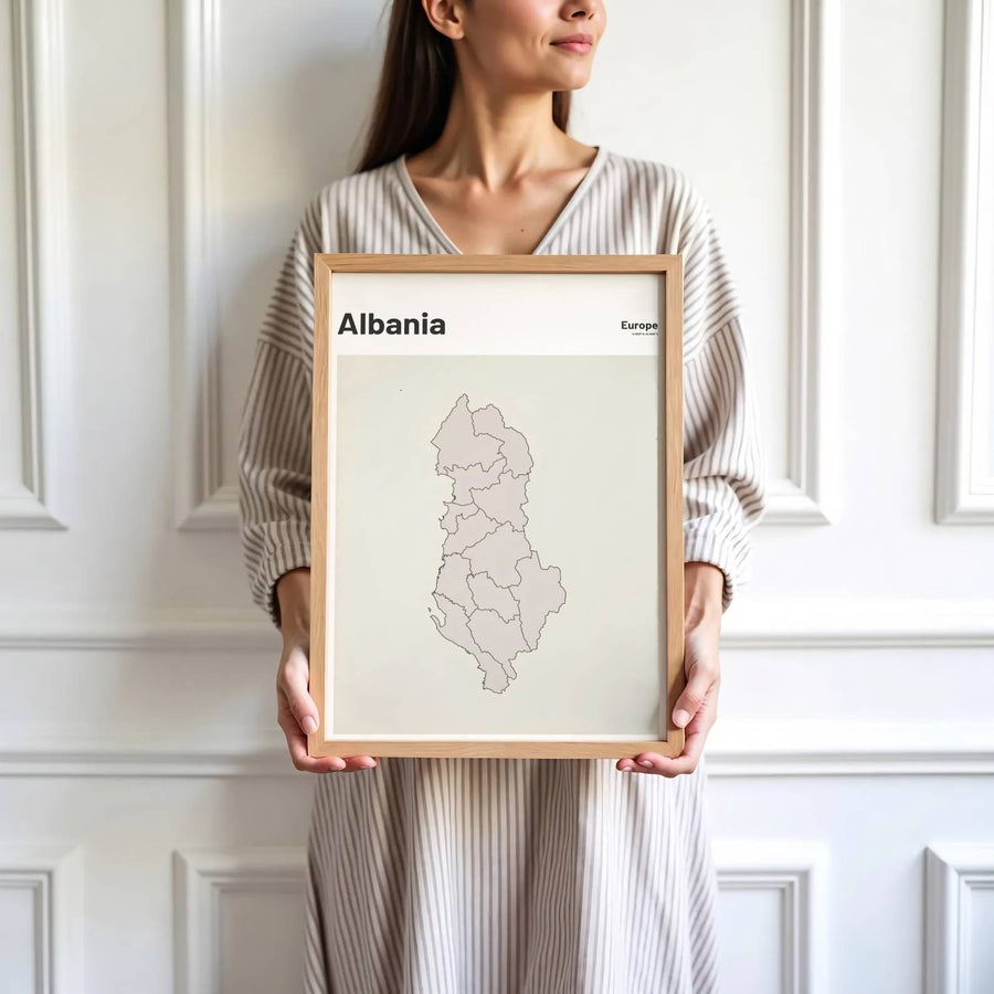 Crisp cartographic artwork showing the country map of Albania in dark vector outlines with modern sans-serif header text and coordinate details. Offered by MapYourDreams, this artwork is available in flexible options including unframed paper, custom wooden frames, and gallery canvas wraps.
