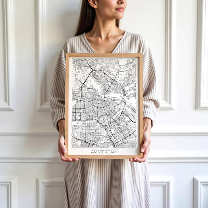 Sophisticated European cartography print of an Amsterdam street map with crisp black lines on a white background, presented by MapYourDreams where customers can choose from unframed paper posters, ready-to-hang canvas, or custom framed wall decor options.