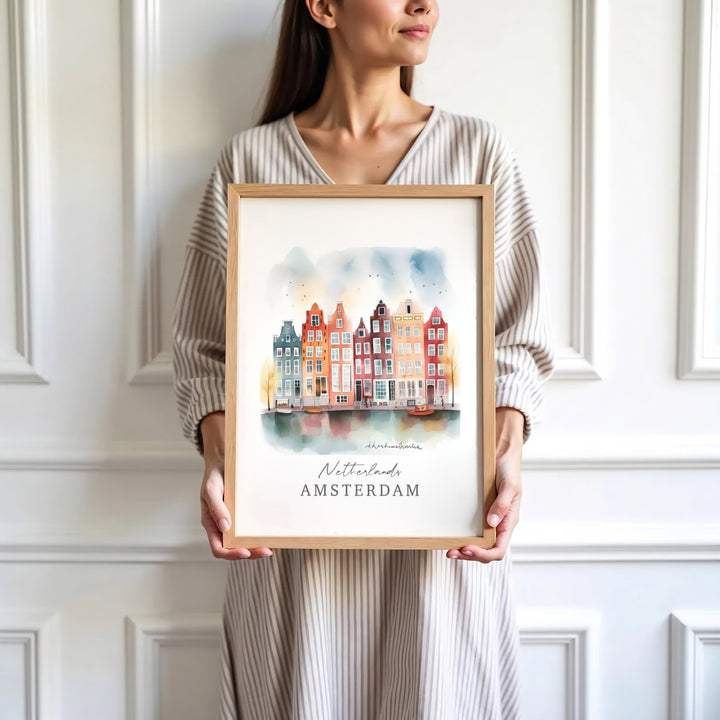 Contemporary watercolor-style fine art print of an Amsterdam canal scene with storybook houses and flying birds, presented by MapYourDreams where customers can choose from unframed paper posters, ready-to-hang canvas decor, or custom framed wall art choices.