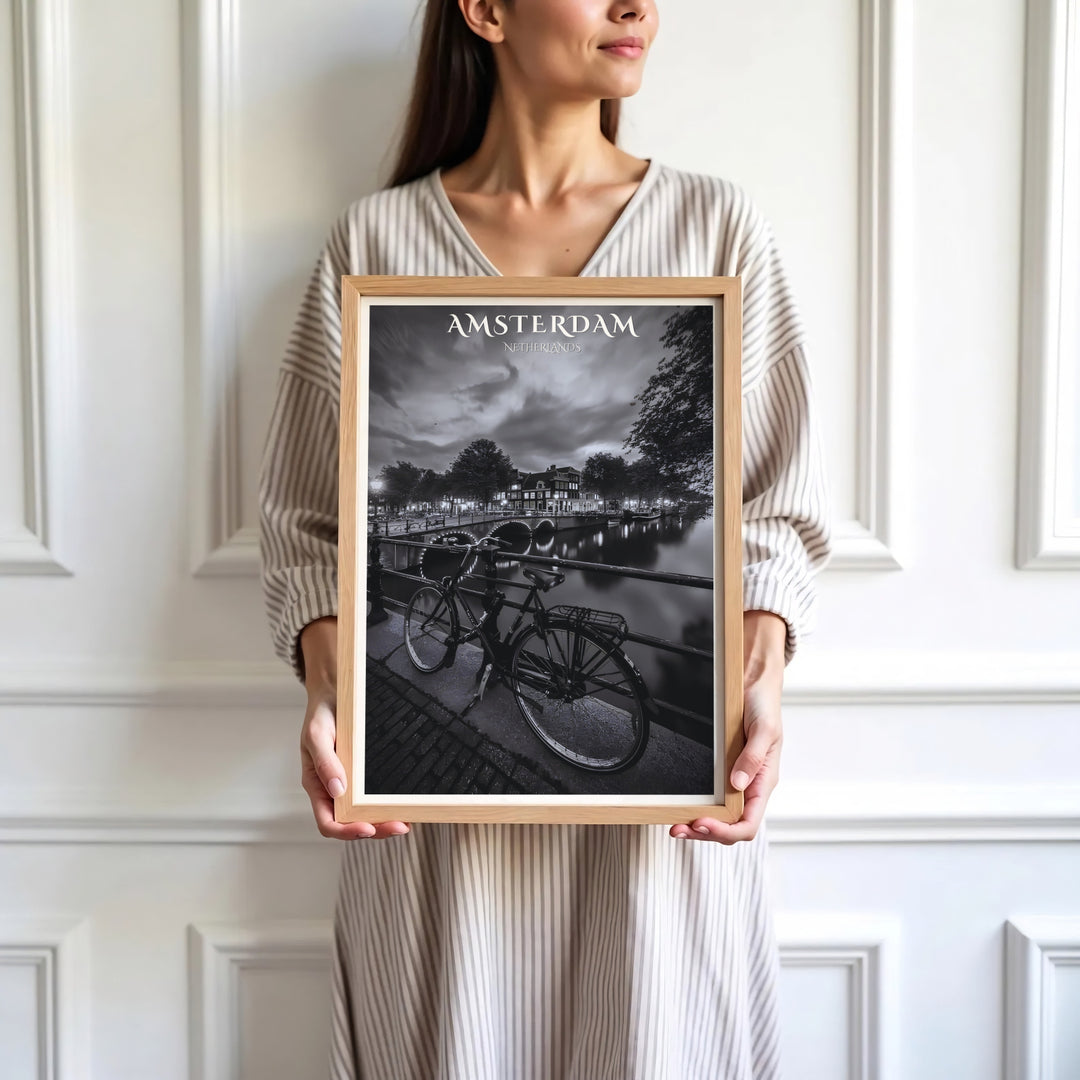 Contemporary monochrome fine art print of an Amsterdam canal scene with a classic bicycle and glowing bridge arches, presented by MapYourDreams where customers can choose from unframed paper posters, ready-to-hang canvas decor, or custom framed wall art choices.