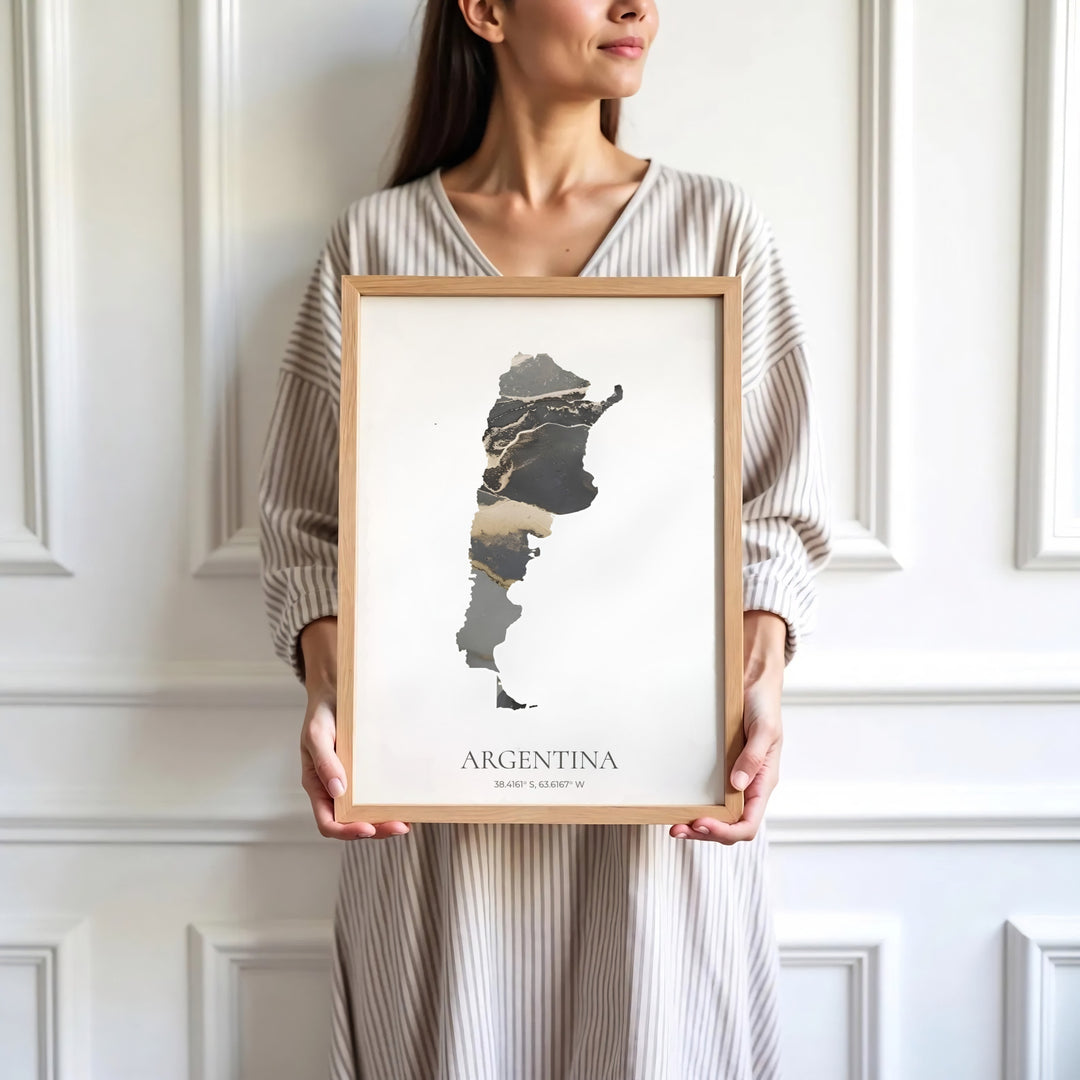 Argentina abstract map art print with sleek black, gold, and grey marble swirls highlighting the southern continent. Made by MapYourDreams, this artistic composition can be purchased as an unframed print, elegantly mounted in wood frames, or produced on stretched canvas.