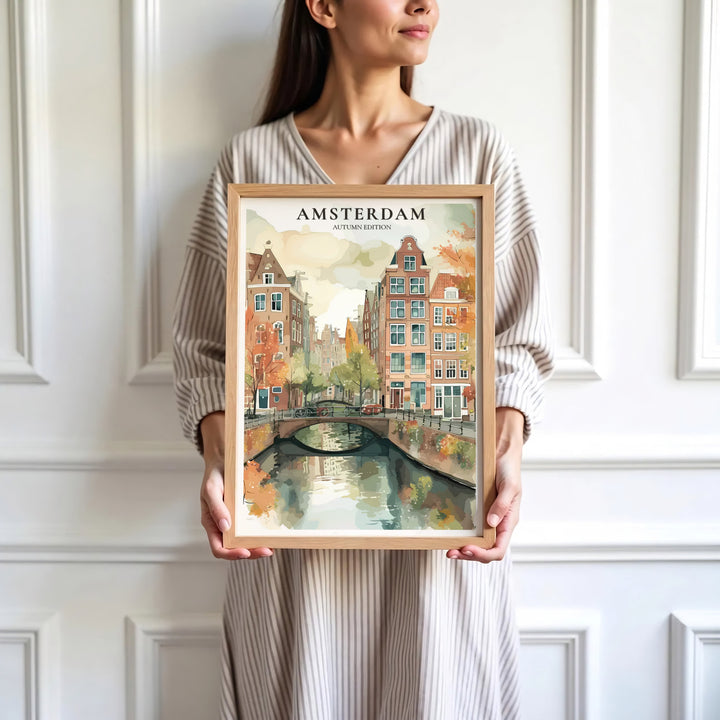 Contemporary watercolor art print of an Amsterdam canal scene with golden autumn trees and historic bridges, presented by MapYourDreams where customers can choose from unframed paper posters, ready-to-hang canvas decor, or custom framed wall art choices.