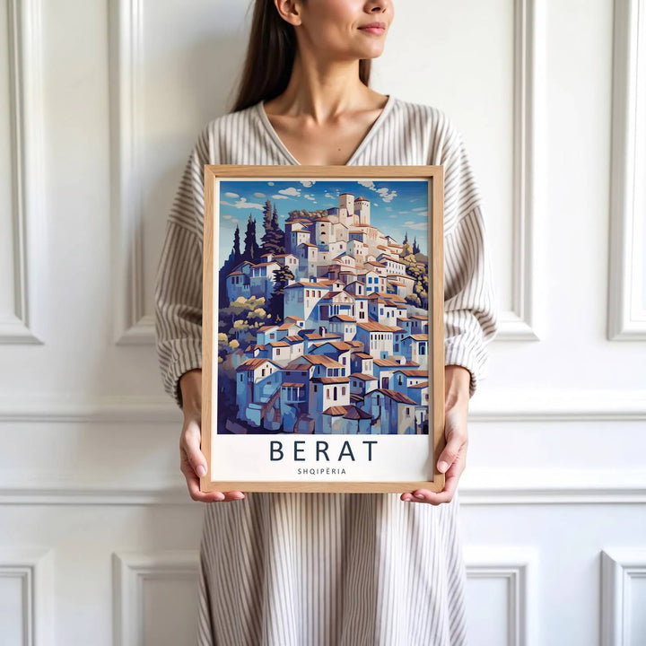 Crisp graphic artwork showing the hillside town of Berat Albania with red clay roofs, white castle watchtower, and blue sky framed with clouds behind. Offered by MapYourDreams, this artwork is available in flexible options including unframed paper, custom wooden frames, and gallery canvas wraps.