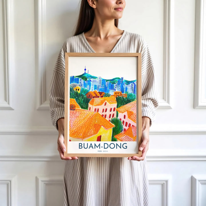 Minimalist white-bordered travel illustration of Buam-dong, Seoul, with text accents and a hand-colored panorama of rooftops, mountains, and N Seoul Tower. Offered by MapYourDreams, this artwork is available in flexible options including unframed paper, custom wooden frames, and gallery canvas wraps.