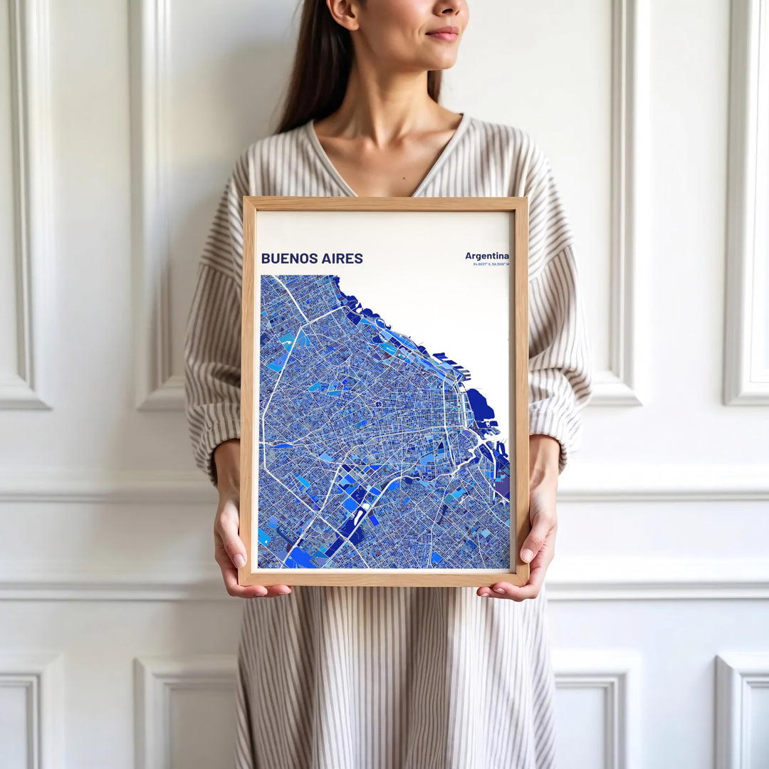 Modern cartographic wall art of Buenos Aires combining navy blue landmass, white roads, and azure geometric accents. Skillfully produced by MapYourDreams, this artwork is provided in multiple formats including unframed paper stock, custom frames, or stretched canvas wraps.