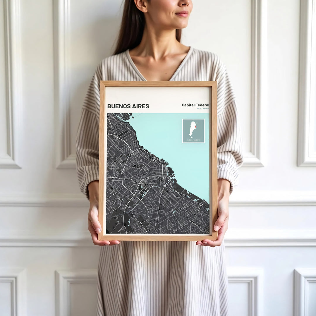 Modern cartographic wall art of Buenos Aires combining charcoal landmass, white roads, and mint green water features. Skillfully produced by MapYourDreams, this artwork is provided in multiple formats including unframed paper stock, custom frames, or stretched canvas wraps.