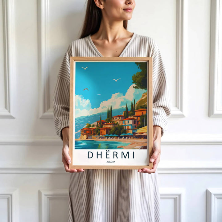 Vibrant turquoise waters gently lap against the shore beneath the iconic red roofs of Dhërmi village in southern Albania. Offered by MapYourDreams, this artwork is available in flexible options including unframed paper, custom wooden frames, and gallery canvas wraps.