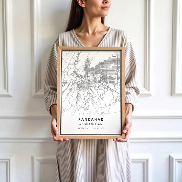 Urban travel map poster depicting the street grid and geographical markers of Kandahar, Afghanistan, bordered by clean black lines. Presented by MapYourDreams as an unframed paper print, a gallery canvas, or a custom framed decor piece in black, natural wood, and white frames for creative workspaces.