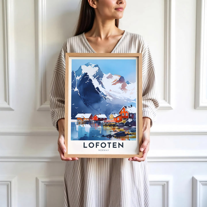 Artistic depiction of the iconic Lofoten scenery in Norway with a dramatic snow peak overlooking red rorbuer cabins. Offered by MapYourDreams, this travel artwork is customizable as an unframed poster print, ready to display framed print, or premium gallery wrap canvas.