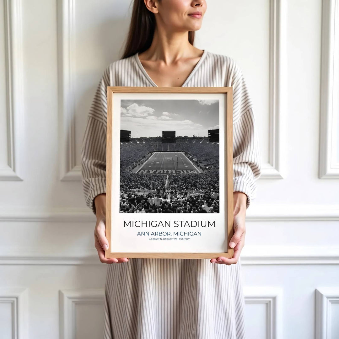 Scenic college football poster of Michigan Stadium rendered in a classic black and white photography art aesthetic. Developed by MapYourDreams, this artwork is available in flexible options including unframed paper, custom wooden frames, and gallery canvas wraps for hallway wall decor.
