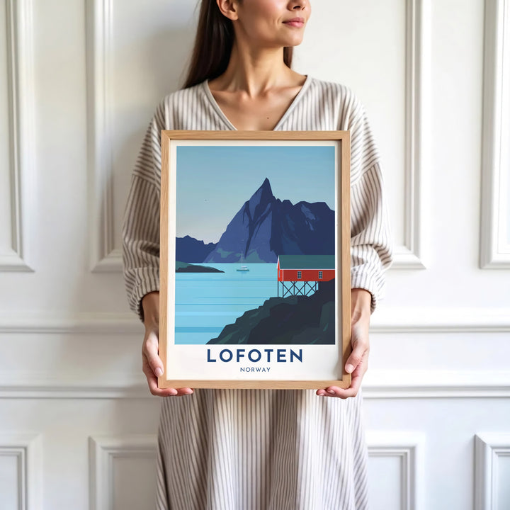 Arctic mountain poster of Lofoten Norway featuring a red fishing cabin on wooden stilts along a serene fjord bay. Decorate your walls with options ranging from simple unframed poster paper to sturdy custom wood frames and stretched canvas wall displays.