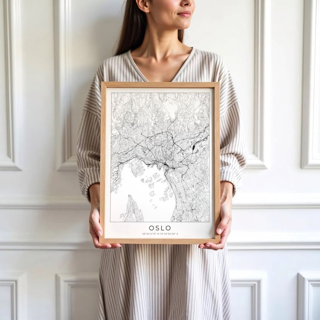 Monochrome vector city print showing the complete urban street grid of Oslo Norway with centered coordinate details. Designed for home decor, select between lightweight unframed paper prints, solid wood display frames, or gallery wrapped canvas panels.