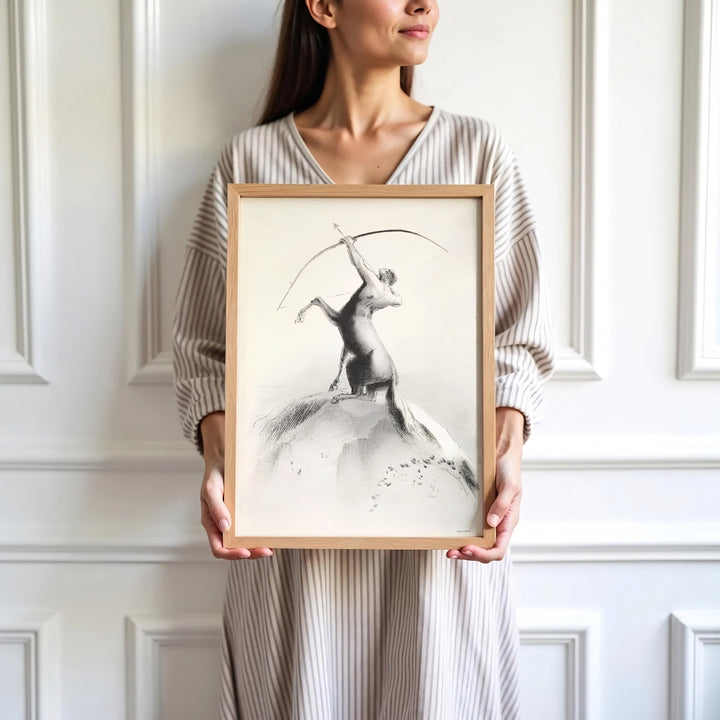 Subtle 1895 pencil-style lithograph Centaur Aiming At The Clouds by Odilon Redon, capturing vintage mythic drama. Elevate your home interior with options ranging from unframed paper prints to custom glass framing and gallery canvas wraps by MapYourDreams.