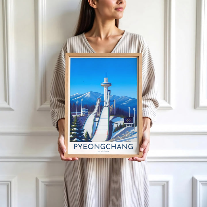 Minimalist white-bordered travel print of Pyeongchang, South Korea, highlighting the sleek lines of the Alpensia Ski Jump ramps against snow-dusted pine trees and blue sky. Offered by MapYourDreams, this artwork is available in flexible options including unframed paper, custom wooden frames, and gallery canvas wraps.