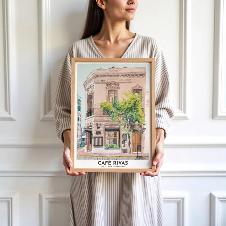 Looking across the cobblestone street toward the historic cafe entrance, this San Telmo Cafe Rivas wall art frames the building in soft watercolor washes, presented by MapYourDreams with versatile possibilities like unframed prints, solid wood frames, and premium canvas wraps.