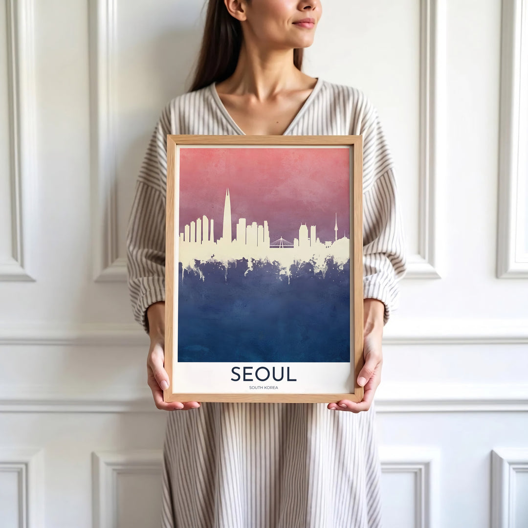 High-contrast watercolor poster featuring the silhouetted cityscape of Seoul, South Korea, separated by a soft pink upper sky and rich dark blue bottom canvas. Offered by MapYourDreams, this artwork is available in flexible options including unframed paper, custom wooden frames, and gallery canvas wraps.