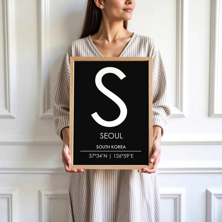 Sleek black background initial poster depicting the letter S and coordinates of seoul south korea, available at MapYourDreams in varied choices including unframed art prints, custom frames, and wrapped canvas designed to elevate any modern interior setting.