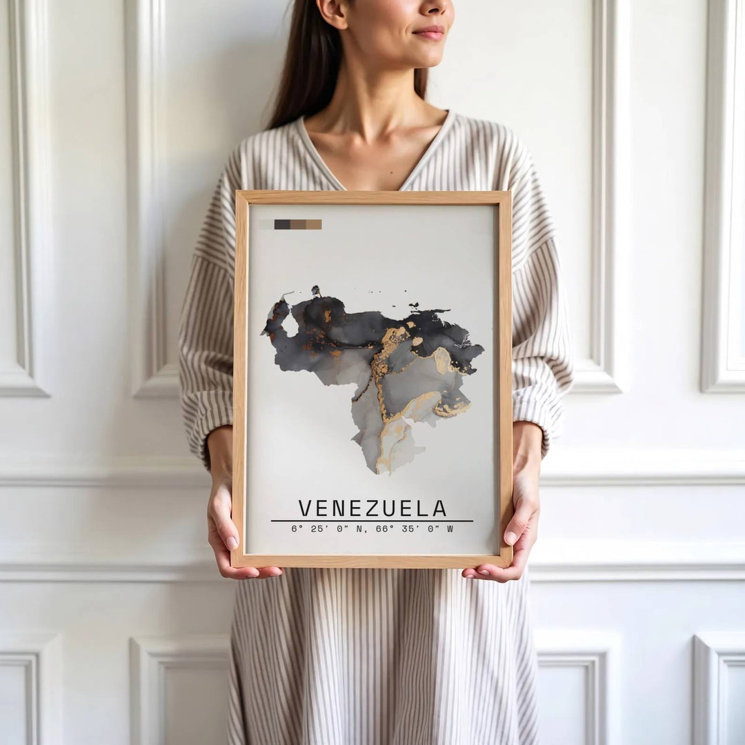 Saturated charcoal and gold travel print showing the fluid ink country shape and national coordinates of Venezuela. Skillfully produced by MapYourDreams, this artwork is provided in multiple formats including unframed paper stock, custom frames, or stretched canvas wraps.