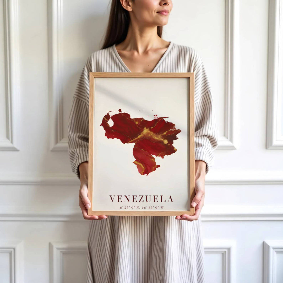 Saturated crimson and gold travel print showing the fluid ink country shape and national coordinates of Venezuela. Skillfully produced by MapYourDreams, this artwork is provided in multiple formats including unframed paper stock, custom frames, or stretched canvas wraps.