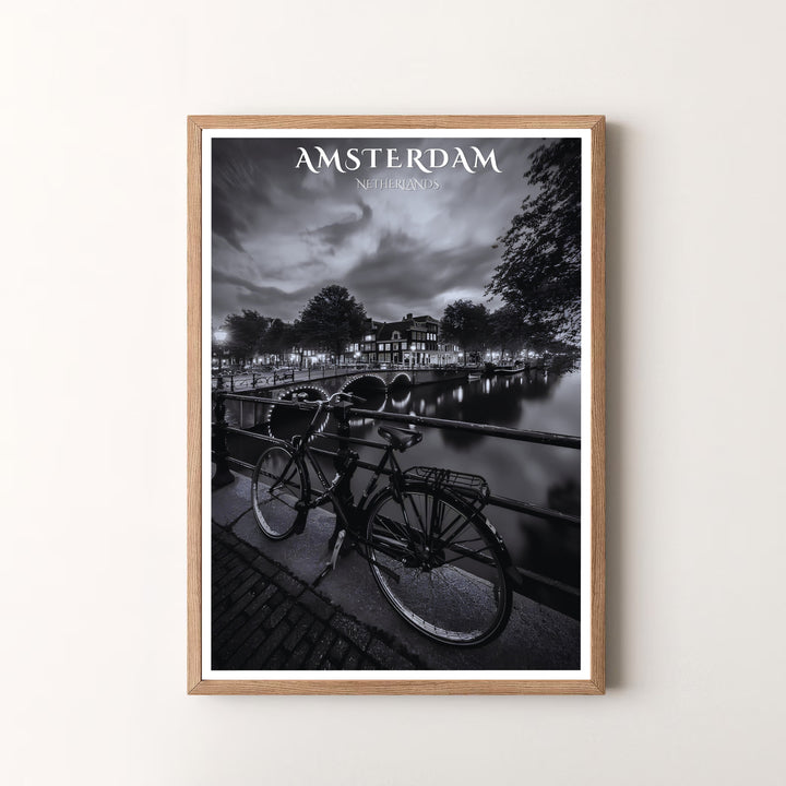 Dramatic photo art piece detailing a Dutch bicycle, illuminated bridge, and dark canal waters in Amsterdam Netherlands, available at MapYourDreams as an unframed print, a stretched canvas, or custom framing options to complement statement wall setups.