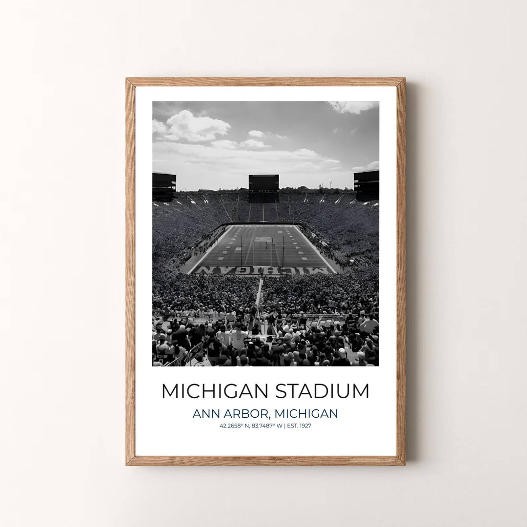 Travel poster of Ann Arbor Michigan featuring Michigan Stadium in black and white under a cloud dappled sky. Prepared by MapYourDreams, this artwork is available in flexible options including unframed paper, custom wooden frames, and gallery canvas wraps for chic home decor.