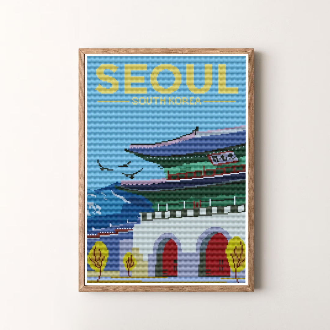 Fine art cross-stitch style poster of Seoul, South Korea, depicting the striking architectural geometry of Gwanghwamun Gate against a sky-blue woven fabric backdrop. Offered by MapYourDreams, this artwork is available in flexible options including unframed paper, custom wooden frames, and gallery canvas wraps.